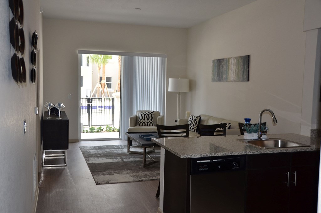 A living room with a sliding door leading to a patio.