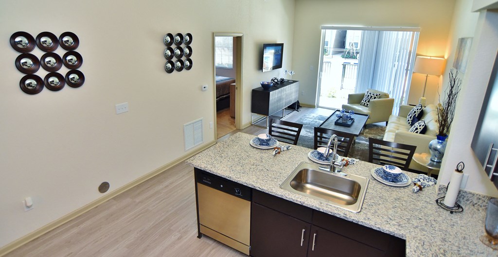 A kitchen with a sink and a counter.