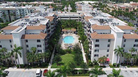 A large apartment complex with a pool in the middle.