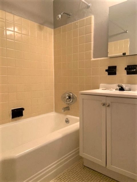 a bathroom with a tub and a sink and a mirror