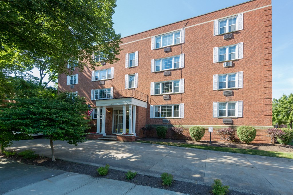 a brick building with a tree in front of it