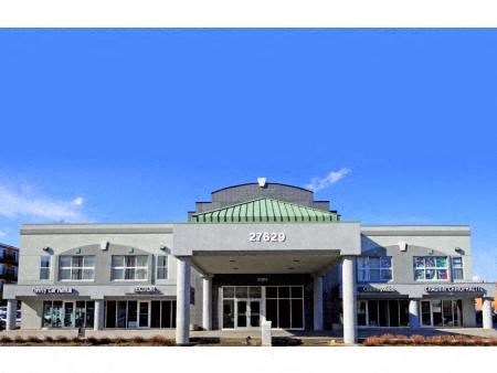 the front of a building with a clear blue sky