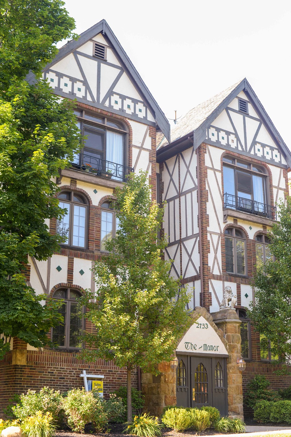 the facade of a building with a tree in front of it