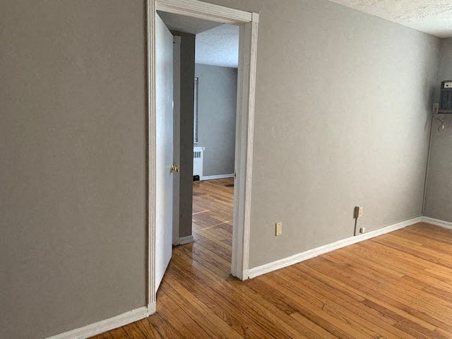 an empty room with a wooden floor and a door