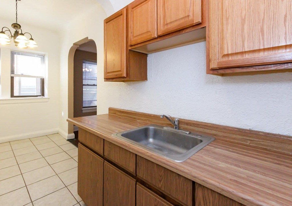 a kitchen with a sink and wooden cabinets