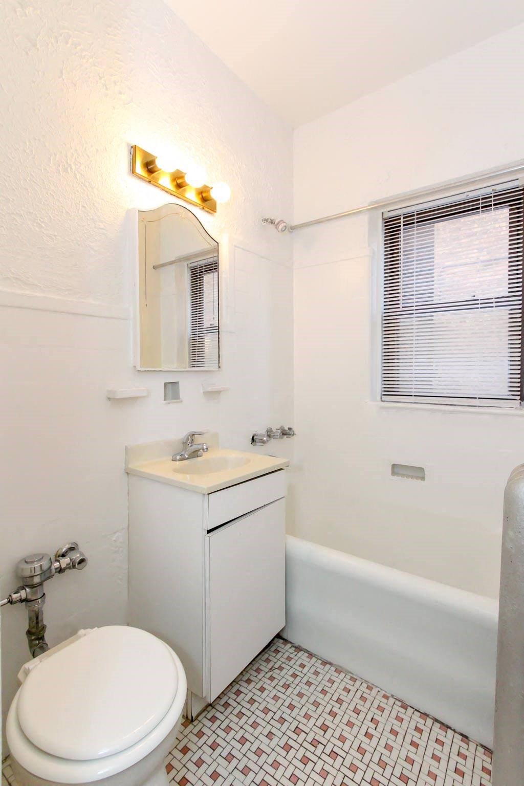 a white bathroom with a toilet and a sink