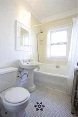 a white bathroom with a toilet and a sink