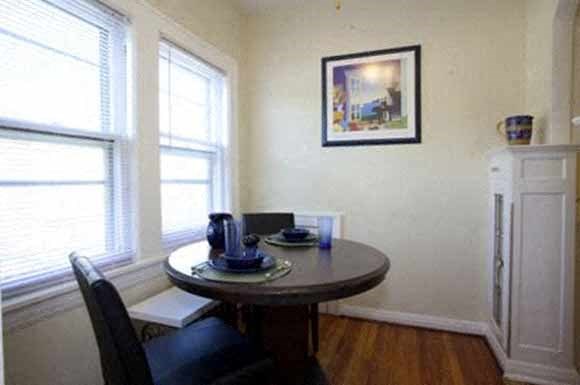 a small dining room with a table and chairs