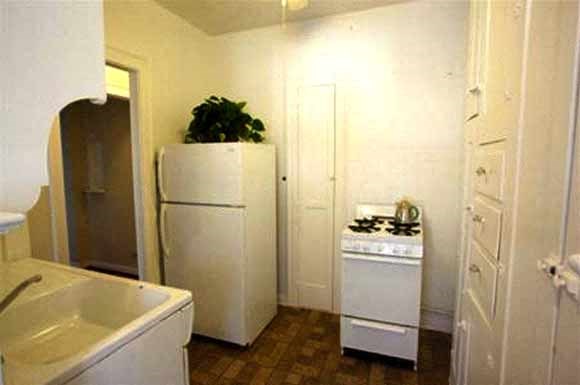 a kitchen with a refrigerator and a stove and a sink