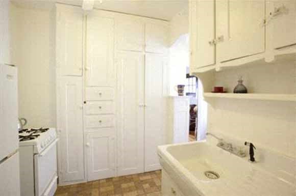 a white kitchen with a sink and a stove