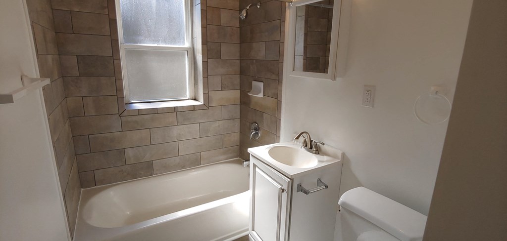 a small bathroom with a sink and a bath tub