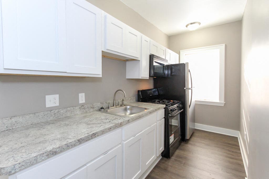 a kitchen with a sink and a refrigerator