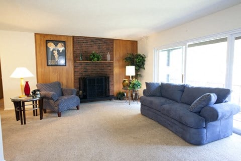 a living room with a blue couch and a fireplace
