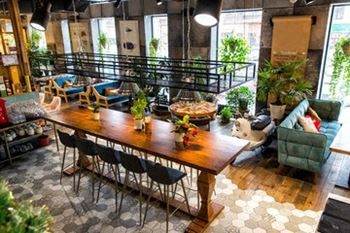 a large living room with a wooden table and chairs