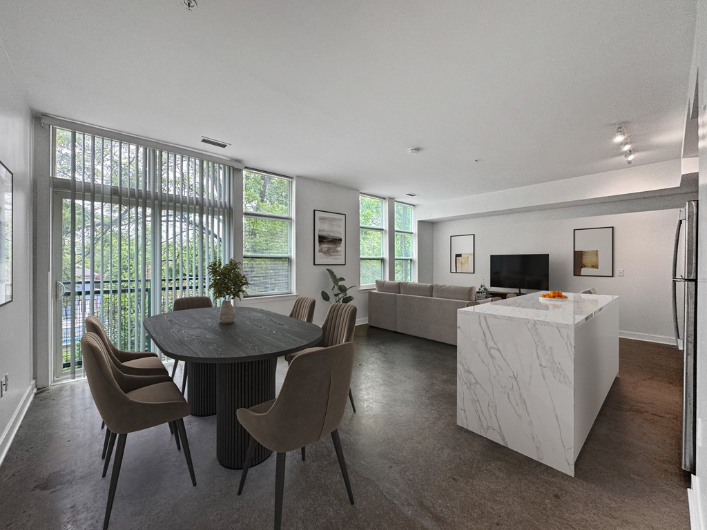 A modern dining room with a round table and chairs.