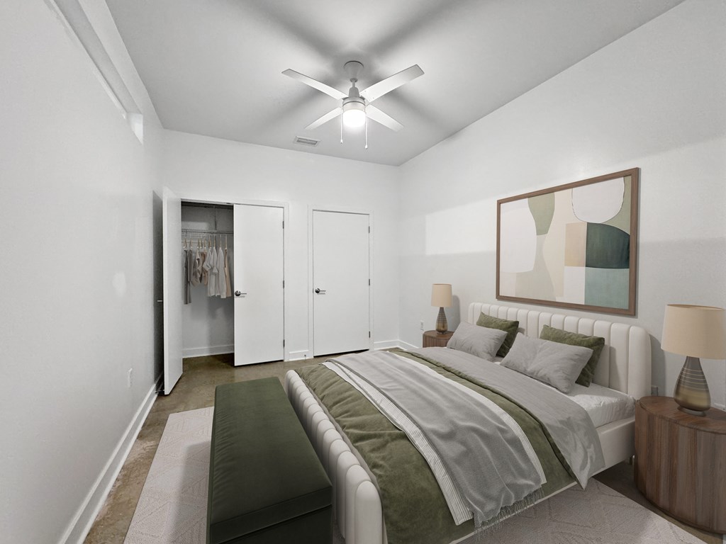 A bedroom with a bed, nightstand, and a painting on the wall.