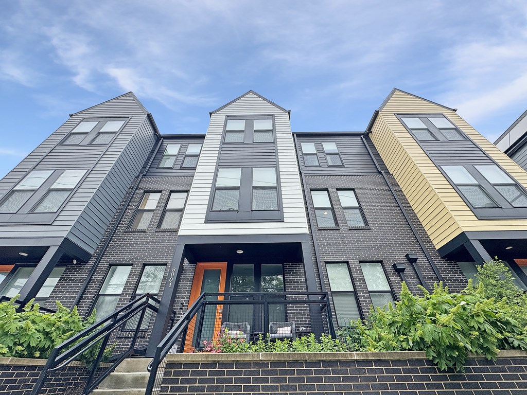 A modern building with a unique design featuring a combination of grey and yellow panels.