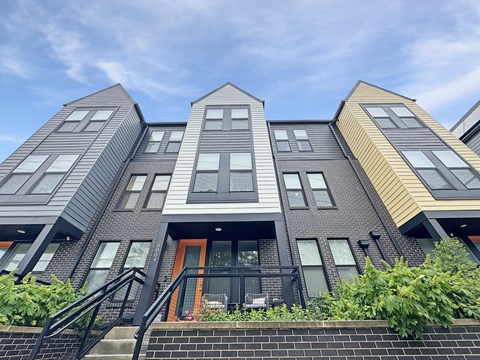A modern building with a unique design featuring a combination of grey and yellow panels.