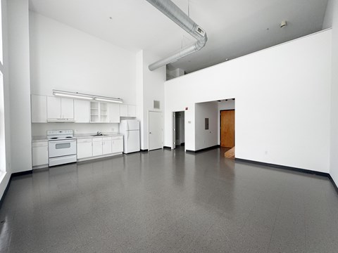 A spacious kitchen with white cabinets and appliances.
