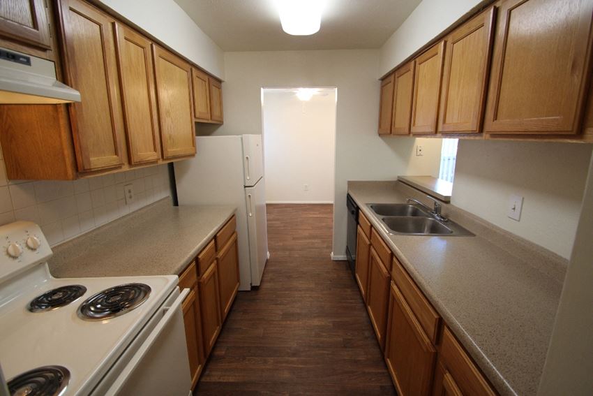 This is a photo of the kitchen of an apartment at Preston Park Apartments in Dallas, TX - Photo Gallery 1