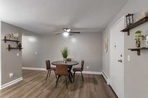 A dining room with a table and chairs in a 1 bedroom, 1 bath 560 square foot apartment at Aspen Village Apartments in the Westwood neighborhood of Cincinnati, OH.