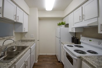 This is a photo of the kitchen in a 704 square foot 1 bedroom apartment at The Boulders Apartments in Garland, TX.