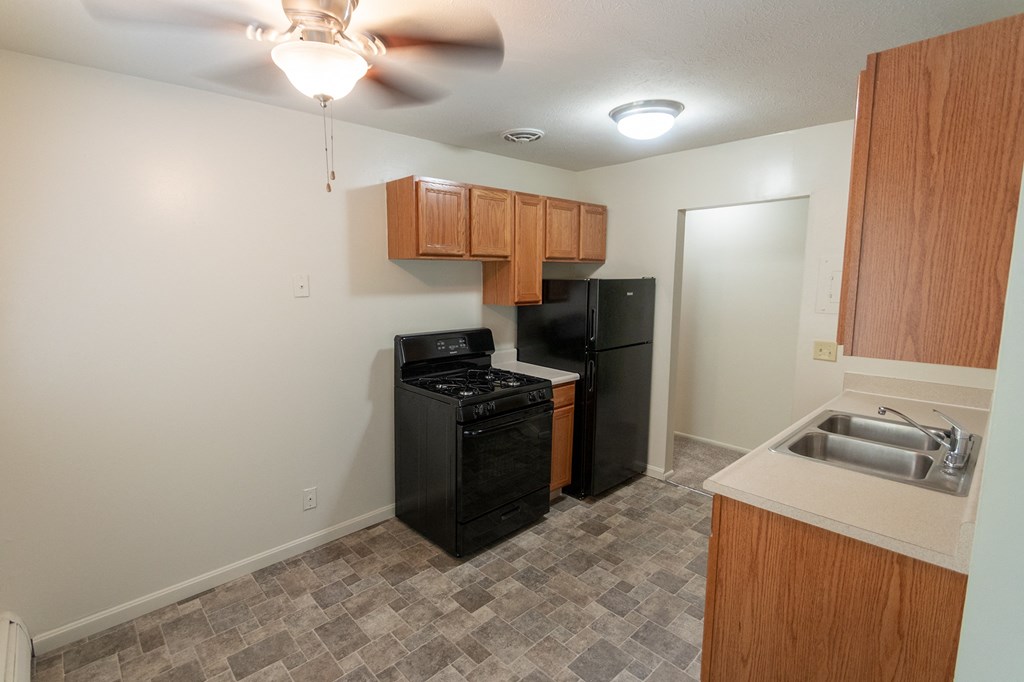 This is a photo of the dining room and kitchen in the 865 square foot, 2 bedroom, 1 and a half bath apartment at Blue Grass Manor Apartments in Erlanger, KY.