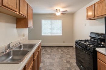 This is a photo of the kitchen and dining room in the 865 square foot, 2 bedroom, 1 and a half bath apartment at Blue Grass Manor Apartments in Erlanger, KY. - Photo Gallery 25