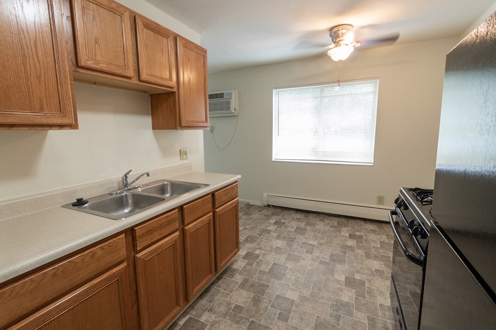 This is a photo of the kitchen and dining room in the 865 square foot, 2 bedroom, 1 and a half bath apartment at Blue Grass Manor Apartments in Erlanger, KY.