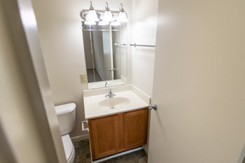 This is a photo of primary half bath in the 902 square foot, 2 bedroom, 1 and a half bath apartment at Blue Grass Manor Apartments in Erlanger, KY. - Photo Gallery 46