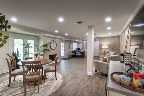 Bluegrass Manor leasing office interior with guest seating, a beverage station, office counter, and open lounge-style community space.