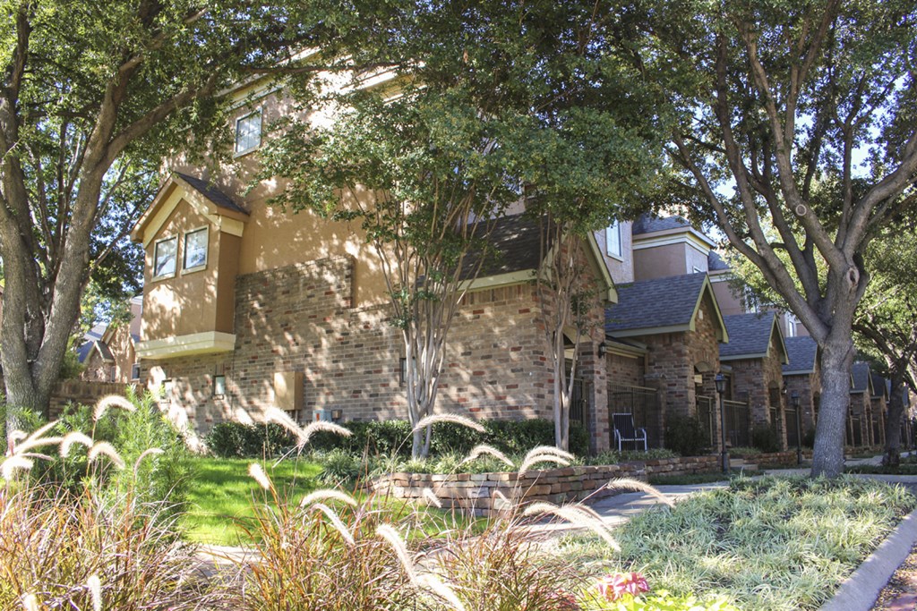 This is a photo of some Townhome exteriors at The Brownstones Townhome Apartments in Dallas, TX.