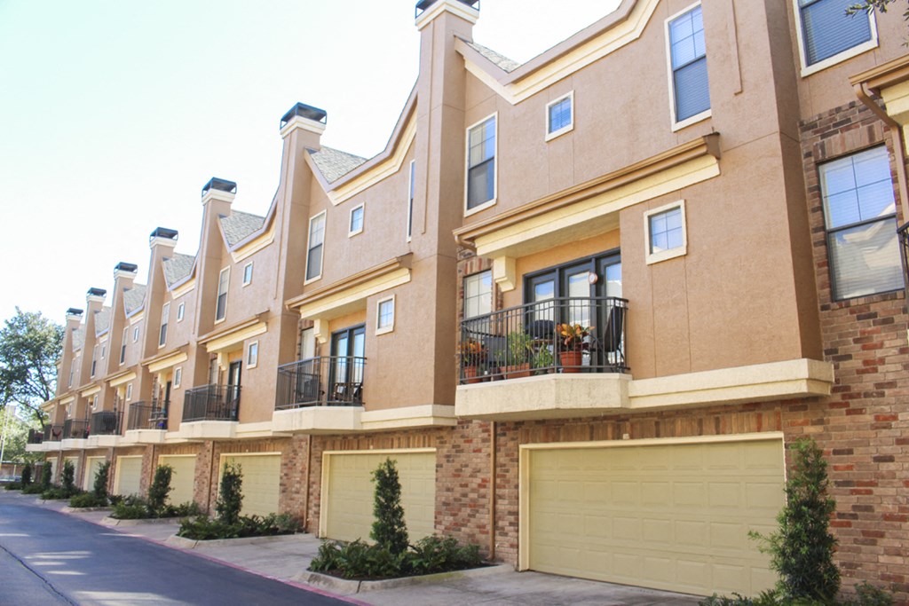 This is a photo of some Townhome exteriors at The Brownstones Townhome Apartments in Dallas, TX.