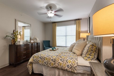 This is a photo of the bedroom of the 826 square foot 1 bedroom apartment at The Brownstones Townhome Apartments in Dallas, TX.