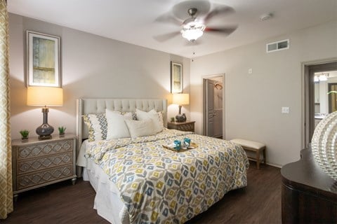 This is a photo of the bedroom of the 826 square foot 1 bedroom apartment at The Brownstones Townhome Apartments in Dallas, TX.