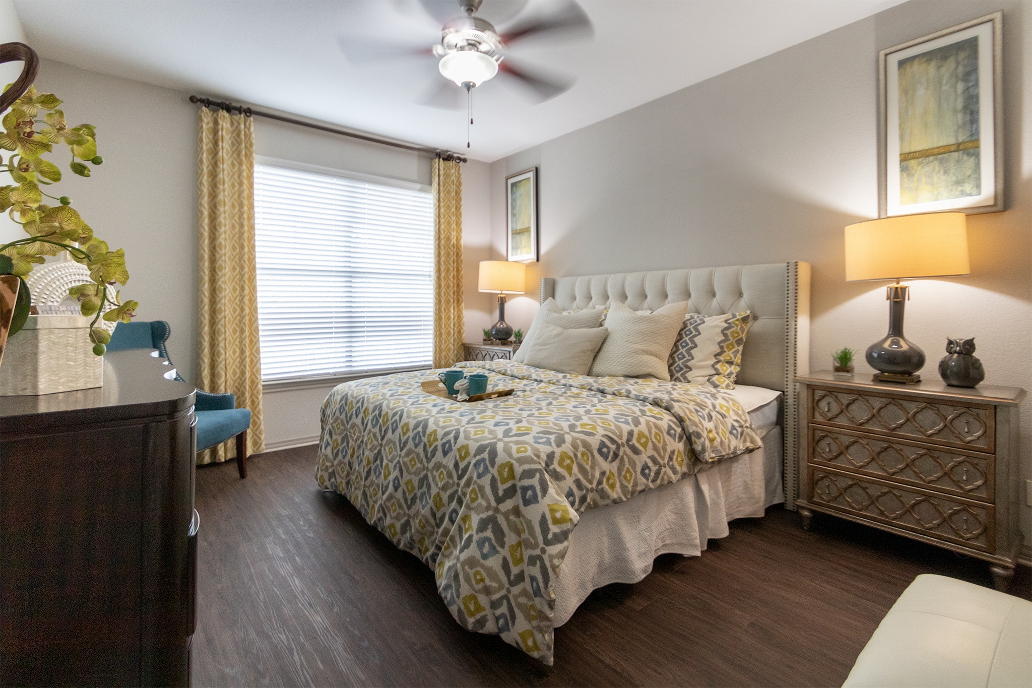 a bedroom with a bed and a ceiling fan