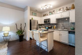 This is a photo of the kitchen in the 826 square foot 1 bedroom , 1 bath apartment at The Brownstones Townhome Apartments in Dallas, TX.