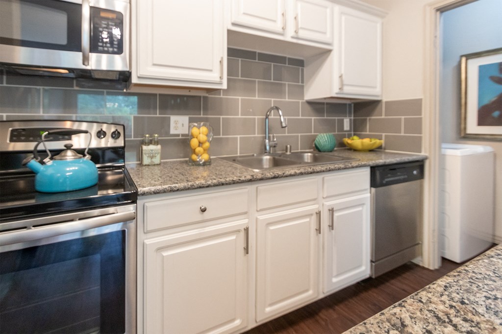 This is a photo of the kitchen in the 826 square foot 1 bedroom , 1 bath apartment at The Brownstones Townhome Apartments in Dallas, TX.