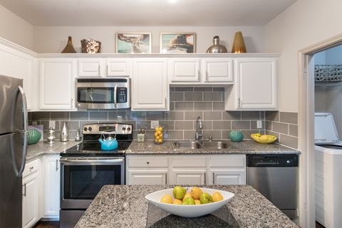 This is a photo of the kitchen in the 826 square foot 1 bedroom , 1 bath apartment at The Brownstones Townhome Apartments in Dallas, TX.
