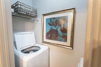 This is a photo of the utility closet with washer and dryer connections in the 826 square foot 1 bedroom , 1 bath apartment at The Brownstones Townhome Apartments in Dallas, TX.