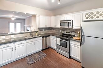 This is a photo of the kitchen of the 1661 square foot 3 bedroom, 3 and a half bath floor plan at The Brownstones Townhome Apartments in Dallas, TX.