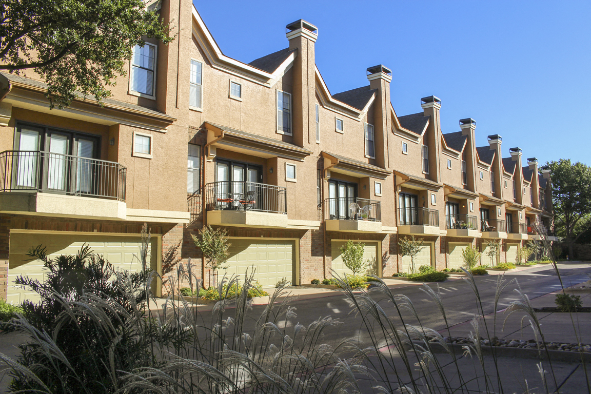 This is a photo of some Townhome exteriors at The Brownstones Townhome Apartments in Dallas, TX.