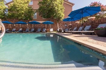 This is a photo of the pool area at The Brownstones Townhome Apartments in Dallas, TX.