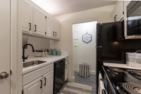 the preserve at ballantyne commons apartment kitchen with black appliances and white cabinets