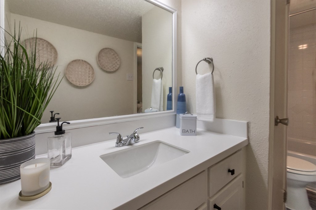 This is a photo of the bathroom in a 692 square foot 1 bed, 1 bath model aprtment at Cambridge Court Apartments in Dallas Texas