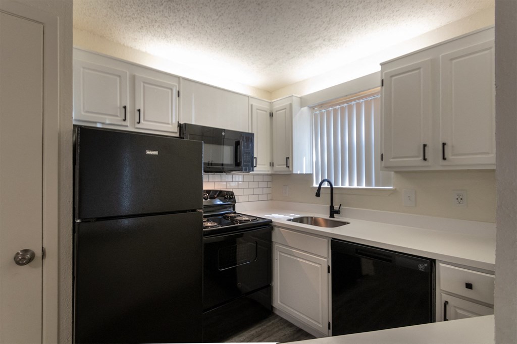 This is a photo of the kitchen in the 450 square foot efficiency apartment at Cambridge Court Apartments in Dallas, TX.