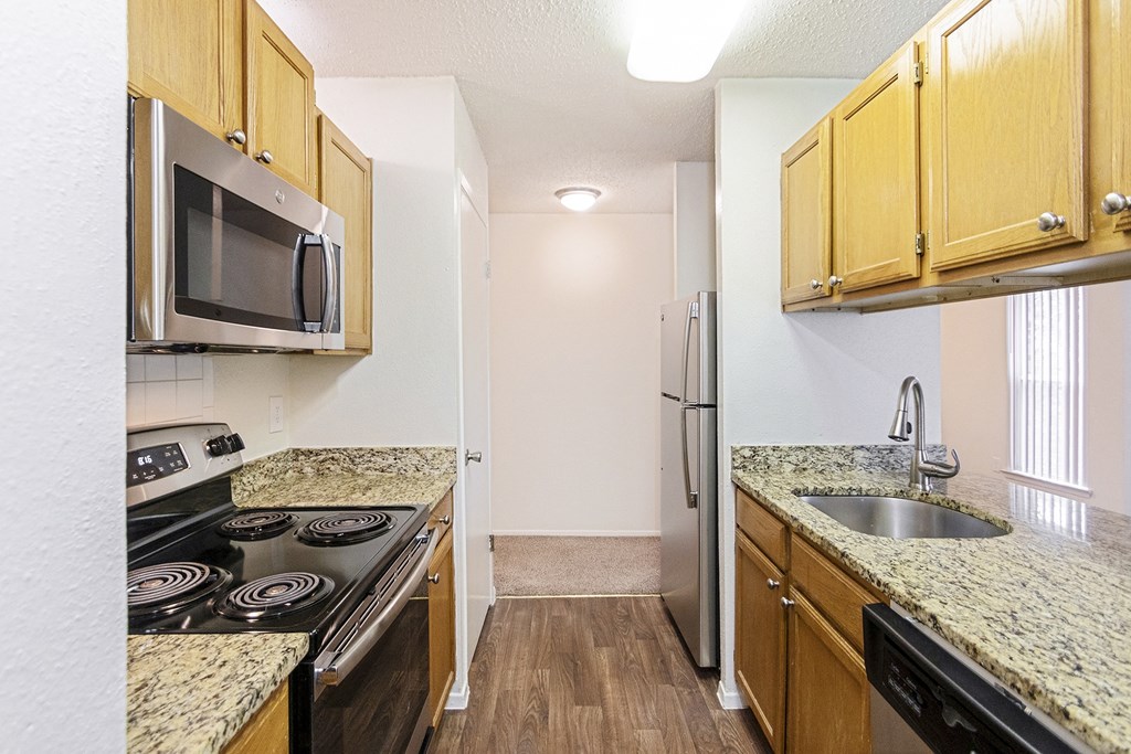 This is a photo of the kitchen in the 1245 square foot 2 bedroom, 2 bath apartment at Cambridge Court Apartments in Dallas, TX.