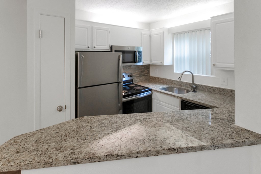 This is a photo of the kitchen in the 450 square foot efficiency apartment at Cambridge Court Apartments in Dallas, TX.