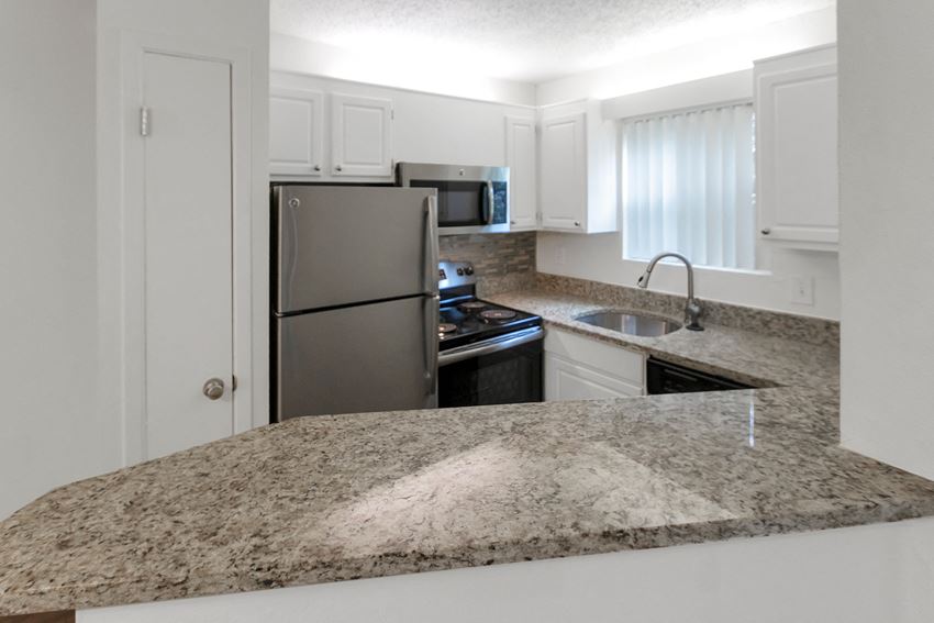This is a photo of the kitchen in the 450 square foot efficiency apartment at Cambridge Court Apartments in Dallas, TX. - Photo Gallery