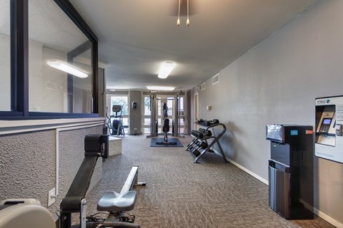 The fitness center with rowing machine, elliptical, treadmill, bike, weight system and free weights at Cambridge Court Apartments in Lake Highlands, Dallas, TX.